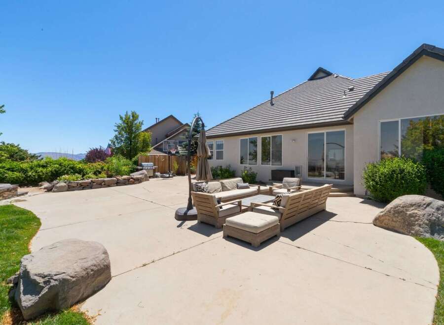 Enjoy outdoor living at its finest with this spacious backyard featuring a large concrete patio perfect for entertaining.