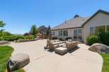 Enjoy outdoor living at its finest with this spacious backyard featuring a large concrete patio perfect for entertaining.