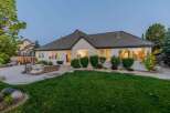 This stunning single-story home boasts a spacious backyard perfect for entertaining, featuring a large patio with comfortable outdoor seating and a built-in grill.