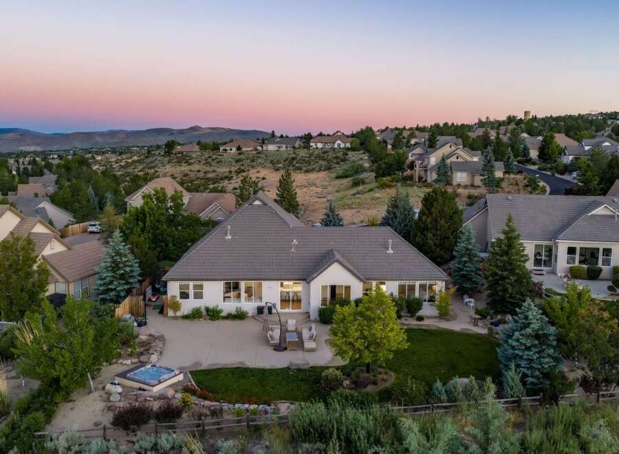 Experience luxury living in this stunning home, featuring a spacious backyard with a relaxing hot tub and a large patio perfect for entertaining.