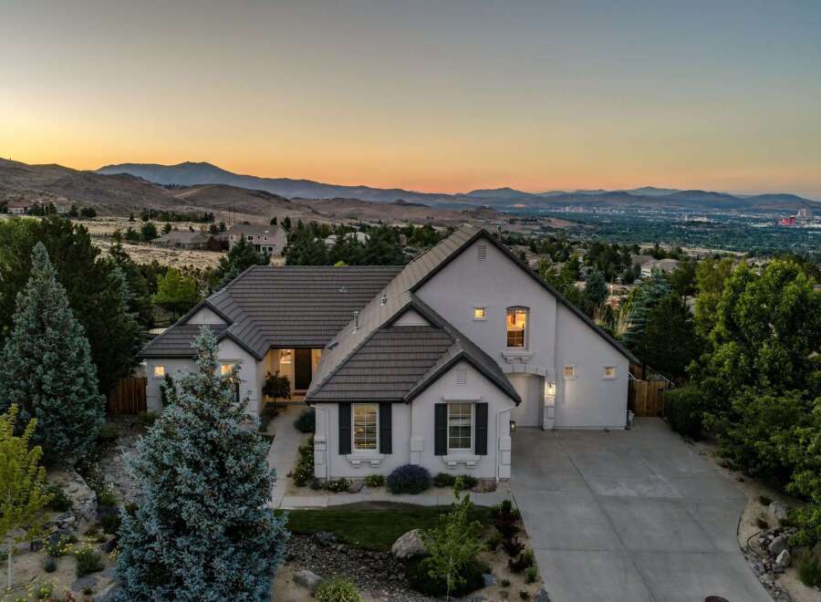 Experience breathtaking panoramic views from this stunning modern home, perfectly situated to capture the expansive mountain vistas and city lights.
