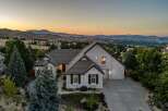 Experience breathtaking panoramic views from this stunning modern home, perfectly situated to capture the expansive mountain vistas and city lights.