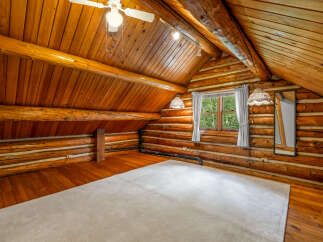 Experience rustic charm in this cozy log cabin loft, featuring warm wooden interiors and exposed beams.