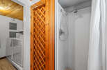 Discover convenience with this laundry area featuring a washer and dryer, adjacent to a charming wooden lattice door.