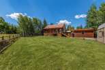 Experience rustic charm in this beautiful log home, nestled amidst mature trees and featuring a spacious wrap-around deck perfect for outdoor entertaining.
