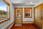 Step into this charming entryway featuring warm wooden accents and a durable, attractive hardwood floor.