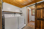 This laundry room features a stacked white washer and dryer, perfect for maximizing space.