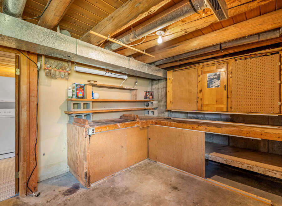 Discover a versatile workshop space in this basement, perfect for DIY projects and storage.