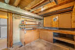 Discover a versatile workshop space in this basement, perfect for DIY projects and storage.