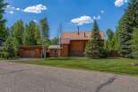 Experience rustic charm in this log home featuring a durable metal roof and a cozy attached garage.