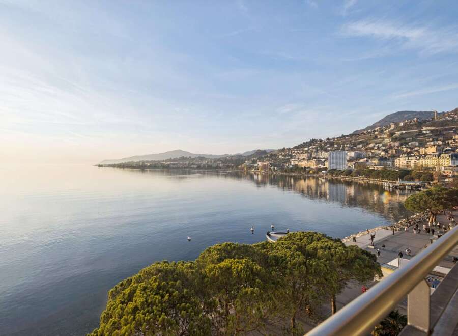 Experience breathtaking lakefront living with panoramic views of the serene waters and a charming hillside city.