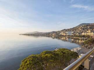 Experience breathtaking lakefront living with panoramic views of the serene waters and a charming hillside city.