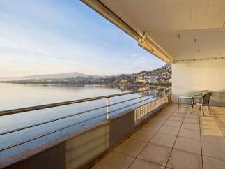 Experience breathtaking lake views from this expansive balcony, perfect for enjoying your morning coffee or evening relaxation.