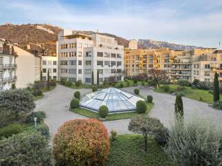 Discover this stunning property featuring a modern architectural design with a unique glass-domed atrium at its center.