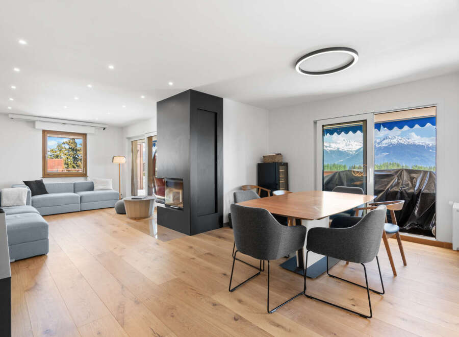 Experience modern living in this spacious open-concept home, featuring a sleek fireplace as the centerpiece of the living area.