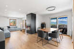 Experience modern living in this spacious open-concept home, featuring a sleek fireplace as the centerpiece of the living area.
