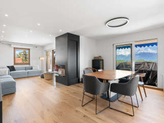 Experience modern living in this spacious open-concept home, featuring a sleek fireplace as the centerpiece of the living area.