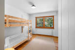 This charming bedroom features a sturdy wooden bunk bed, perfect for families or guests.