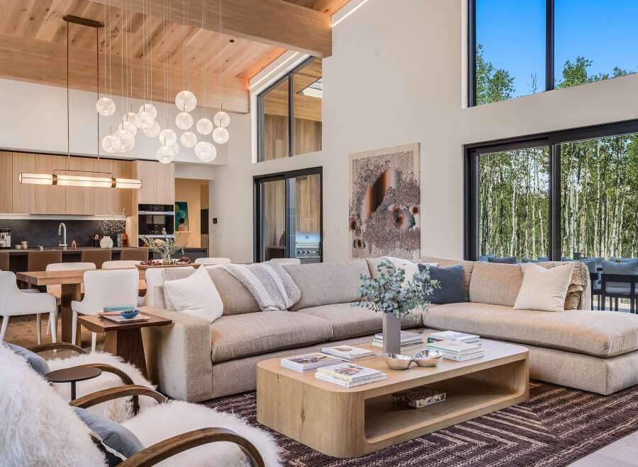 Experience modern luxury in this stunning open-concept living space, featuring a spacious sectional sofa perfect for gatherings.