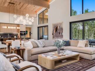 Experience modern luxury in this stunning open-concept living space, featuring a spacious sectional sofa perfect for gatherings.