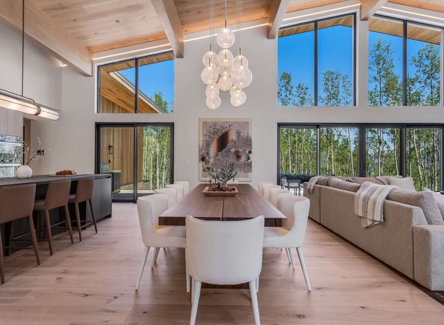 Experience luxurious modern living in this stunning open-concept home, featuring a gourmet kitchen with a breakfast bar and a spacious dining area perfect for entertaining.