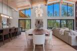 Experience luxurious modern living in this stunning open-concept home, featuring a gourmet kitchen with a breakfast bar and a spacious dining area perfect for entertaining.