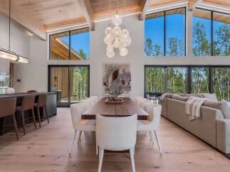 Experience luxurious modern living in this stunning open-concept home, featuring a gourmet kitchen with a breakfast bar and a spacious dining area perfect for entertaining.