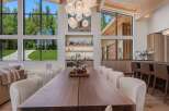 Experience luxury living in this stunning dining area, featuring a grand wooden dining table perfect for gatherings.