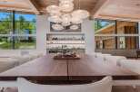 Experience luxurious modern living in this stunning dining room, featuring a grand walnut dining table and plush boucle chairs.