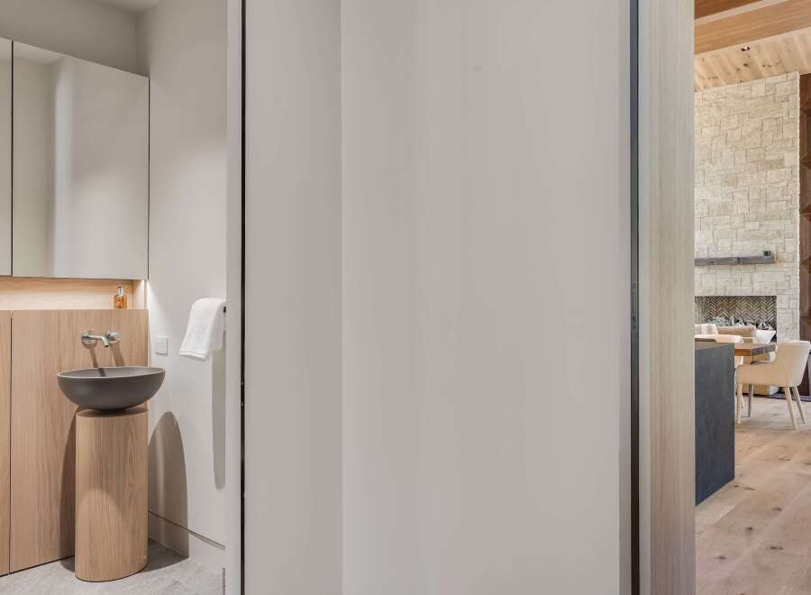 Experience modern luxury in this stunning home, featuring a sleek bathroom with a floating vanity and vessel sink.