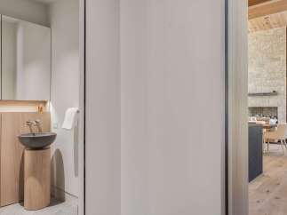 Experience modern luxury in this stunning home, featuring a sleek bathroom with a floating vanity and vessel sink.