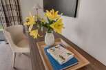 This inviting space features a comfortable armchair and a stylish wooden desk, perfect for work or relaxation.