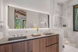 Experience luxury in this modern bathroom featuring a spacious double vanity with sleek stone countertops and integrated sinks.