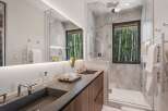 Experience luxury in this modern bathroom featuring dual sinks set in a sleek stone countertop.