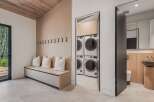Discover modern living with this spacious laundry room featuring stacked washers and dryers for ultimate convenience.