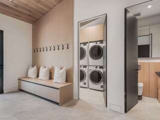 Discover modern living with this spacious laundry room featuring stacked washers and dryers for ultimate convenience.