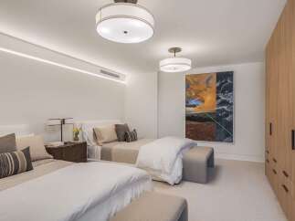 This inviting bedroom features two comfortable beds, perfect for accommodating guests or family.