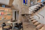 Experience modern luxury in this stunning home featuring a floating staircase with glass railings and warm wood accents throughout.
