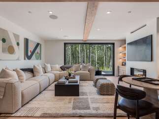Experience modern living with this stunning living room, featuring a plush sectional sofa and a sleek black coffee table.