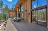 Experience luxurious mountain living with this stunning modern home featuring expansive floor-to-ceiling windows that showcase breathtaking forest views.