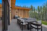 Experience seamless indoor-outdoor living with this stunning modern patio, featuring a spacious dining area perfect for entertaining.