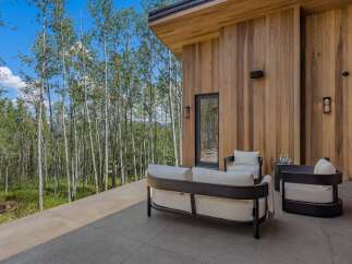 Experience modern luxury with this stunning outdoor living space, featuring sleek, contemporary furniture perfect for relaxing or entertaining.