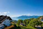 Experience breathtaking panoramic views of a serene lake and majestic snow-capped mountains from this stunning property.