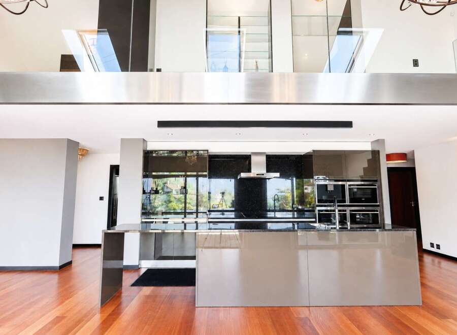 Experience modern luxury in this stunning open-plan living space, featuring a sleek, contemporary kitchen with high-end appliances and a spacious island perfect for entertaining.