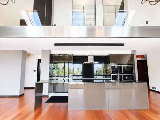 Experience modern luxury in this stunning open-plan living space, featuring a sleek, contemporary kitchen with high-end appliances and a spacious island perfect for entertaining.