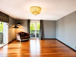 Experience luxurious living in this spacious room featuring a plush velvet sofa and elegant zebra print curtains.