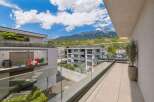Experience modern living with this stunning balcony offering breathtaking mountain and vineyard views.