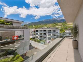 Experience modern living with this stunning balcony offering breathtaking mountain and vineyard views.