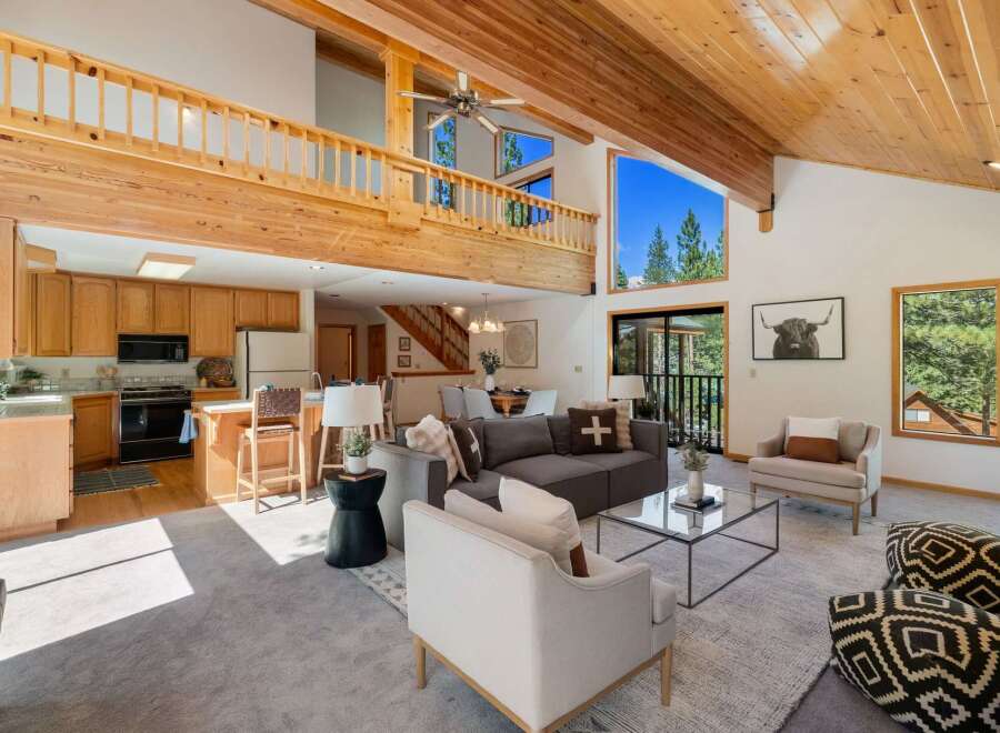 Experience mountain living in this stunning home featuring a spacious open-concept living area with soaring vaulted ceilings and exposed wood beams.