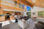 Experience mountain living in this stunning home featuring a spacious open-concept living area with soaring vaulted ceilings and exposed wood beams.